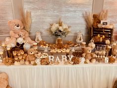 a teddy bear themed baby shower is set up on a table with desserts and candies