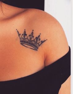 a woman with a crown tattoo on her shoulder