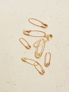 Punk meets polish. The miniature version of our classic Safety Pin Earring pays homage to alternative culture of the ‘80s. Handcrafted from recycled 14Kt gold it’ll make an elevated nod to your inner rebel. 14Kt Gold Safety Pin Earring Length: 16mm Width: 1.5mm Available in yellow or rose gold Sold as a single Made in L.A. Safety Pin Earring, Safety Pin Earrings, Vintage Silhouette, Coin Pearls, Sell Gold, Recycled Gold, Bracelet Collection, Silver Pieces, The 80s