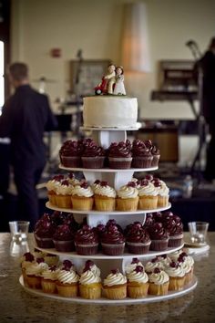 a wedding cake with cupcakes stacked on it