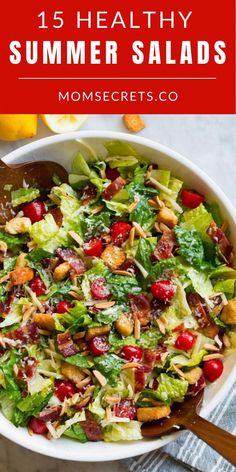 a salad with lettuce, cranberries and almonds in a white bowl