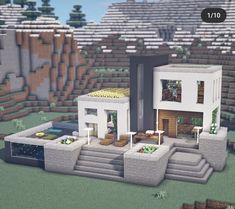 a modern house is shown in the middle of a minecraft landscape with trees and bushes