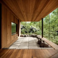 a room with wooden walls and flooring that looks like it is in the woods