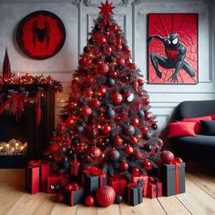 a christmas tree decorated with red and black balls, spiderman ornaments and other decorations