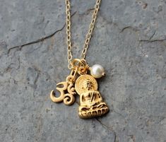 This gorgeous delicate gold necklace features tiny detailed 24k gold plated om symbol, radiant meditating Buddha charm, and white Swarovski pearl or birthstone crystal on a 14k gold filled delicate chain. See Pearl or Birthstone Crystals below for pearl or crystal choices. The Buddha, in his beautiful incarnation, is 1/2 inch tall by 1/4 inch wide. The charm is plain on the back and three dimensional on the front. The om charm is about 1/4 inch tall by 1/4 inch wide. Both are plated with 24k gold - in a very warm rich yellow with a satin finish. The chain is a delicate but sturdy 14k gold filled cable chain with a 14k gold filled lobster clasp. See my other zen themed items here: https://www.etsy.com/shop/winterberryjewelry/?search_query=zen PEARL OR BIRTHSTONE COLORS You can choose betwee Gold Buddha, Meditating Buddha, Om Charm, Delicate Gold Necklace, Buddha Necklace, Buddha Meditation, Swarovski Crystal Beads, Necklace White, Swarovski Pearls