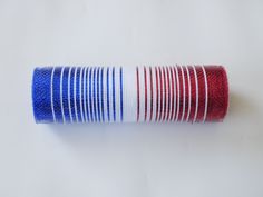 a roll of red, white and blue thread sitting on top of a table