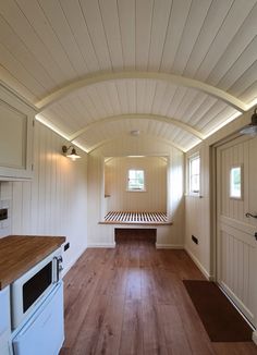 an empty room with wood floors and white walls is seen in this image from the inside