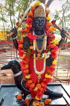 the statue is decorated with flowers and other decorations