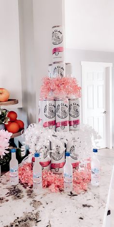 there is a large cake made out of cans and pink flowers on the counter top