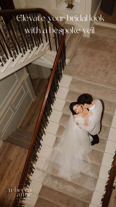 a bride and groom are hugging on the stairs