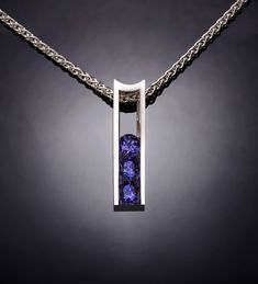 "Alexandrite Necklace - Argentium Silver - 3503 - Argentium Chain Included Make a statement with this modern artisan crafted pendant. Cast in high purity Argentium 960, 100% recycled silver, this pendant measures 22mm x 6mm (7/8\" x 1/4\") and is channel set with three beautiful 4mm Chatham Alexandrites. ( IMPORTANT - PLEASE READ 1. AND 2 BELOW ) 1.) INCLUDED IN THE PRICE IS AN ARGENTIUM SILVER CHAIN APPROPRIATE FOR THE PENDANT CHOSEN. YOU CAN CHOOSE FROM 16\", 18\" OR 20\" LENGTH AT CHECKOUT. 2 Emerald Birthstone Jewelry, Pink Topaz Necklace, Alexandrite Necklace, Argentium Silver Jewelry, Elegant Rings, Yucca Valley, Blue Topaz Necklace, Peridot Necklace, Topaz Necklace