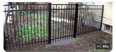 a black metal fence in front of a house