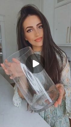 a woman holding up a clear plastic container