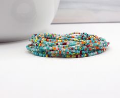 Fiesta No. 4 extra long wrap beaded bracelet. Tiny multi color seed beads boho layering jewelry can be worn as necklace or anklet too. Handmade by Samantha Price at WPshoppe.etsy.com and thewrappepdpixie.com A beachy glass bead bracelet made with my custom color mix of glass seed beads 2mm (11/0) with a few 3mm Czech glass dark beads in the mix. The perfect layering bracelet for any tropical getaway. Layer this glass beaded wrap bracelet with others for a fun flowy look. Details: Fiesta No. 4 To Multi Wrap Bracelet, Layering Jewelry, Boho Layering, Beaded Wrap Bracelets, Beaded Wraps, Color Mix, Glass Beaded Bracelets, Layered Jewelry, Layered Bracelets