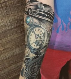 a person with a tattoo on their arm has a clock in the middle of his arm