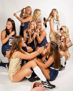 a group of young women sitting next to each other in front of a white background