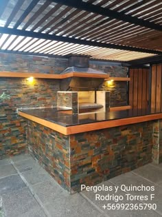 an outdoor kitchen is built into the side of a building