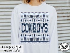 a woman wearing a white sweater with the word cowboys on it and snowflakes