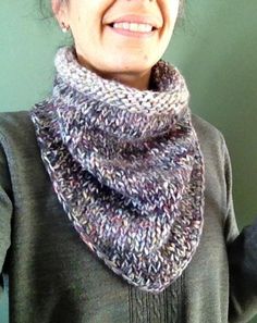 a smiling woman wearing a knitted scarf