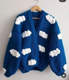 a blue sweater with white clouds on it