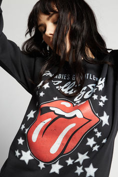 Our next band needs no introduction. This bold graphic sweatshirt features the band's iconic lips and tongue logo with the title of their 1974 movie "Ladies & Gentlemen: The Rolling Stones". Made with soft washed fabric, a crew neckline, ribbed hems, and a slightly fitted style. The Rolling Stones Shirts, Tee Shirt Rolling Stones, Rolling Stones Womens Shoulders Off Shirt, Styling A Rolling Stone Tshirt, Rolling Stones Costume Women, The Black Crowes, Joan Jett, Billy Joel, Janis Joplin