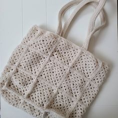 a crocheted bag sitting on top of a white table