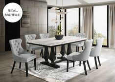 a dining room table with white chairs and a potted plant on the rug in front of it