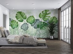 a bed room with a neatly made bed and a plant mural