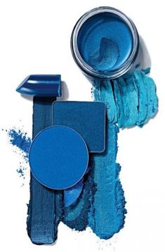 two blue eyeshades, one with an open lid and the other with a powdered eye shadow