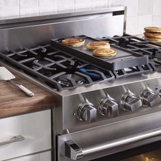 an oven with four pancakes on the burners