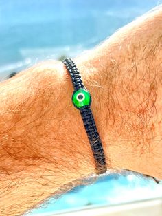 "Green evil eye string braided bracelet protection money bracelet, with easy to use adjustable sliding knot for man woman kid best friend and custom-made to your own wrist size, fashionable and durable handmade to order in USA and designed to last, made from high quality string and a beautiful lampwork glass light green evil eye bead, safe to get wet even while bathing so you can enjoy it on all the time, 120 days guarantee We display your bracelet in a beautiful package ready for gift giving or Green Spiritual Evil Eye Bracelet As Gift, Adjustable Green Evil Eye Bracelets, Adjustable Green Evil Eye Bracelet, Adjustable Casual Evil Eye Jewelry, Adjustable Evil Eye Casual Jewelry, Adjustable Green Evil Eye Spiritual Bracelet, Casual Adjustable Evil Eye Jewelry, Adjustable Green Spiritual Evil Eye Bracelet, Green Adjustable Spiritual Evil Eye Bracelet