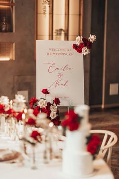 a sign that says welcome to the bride and groom on top of a table with flowers