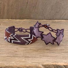 This fun pair of friendship bracelets is crafted by Guatemala's Artisans of Panabaj. The artisans work on small looms to create the two wristbands from tiny glass beads. One bracelet features a star motif in dusty lilac and grape while the other features a star motif in grape dark lilac and wine. Both can be fastened at one of three lengths with a crystal bead. Grape Beaded Bracelet, Handmade Purple Multi-strand Bracelets, Spiritual Hand-strung Purple Bracelets, Bohemian Multi-strand Purple Beaded Bracelets, Purple Bohemian Hand-strung Beads, Dusty Lilac, Star Motif, Buy Bead, Wristbands