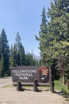 the yellowstone national park sign is in front of some trees