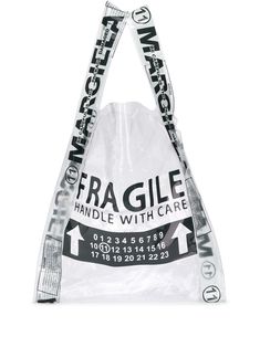 As always, handle Maison Margiela with care. Crafted in Italy, this transparent PVC shopper tote bag is printed with a 'Fragile' slogan on the front. We don't mind whether you put things in it or not. Featuring a sheer construction, top handles, an open-top design and a 'fragile' print. | Maison Margiela Fragile shopper tote Totes Ideas, Designer Totes, Zuhair Murad, Eco Bag, Paris Hilton, Shopper Tote, Diy Bag, Tote Bag Design, Primavera Estate