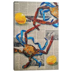 an image of a crab made out of newspaper paper with blue ribbon and lemons