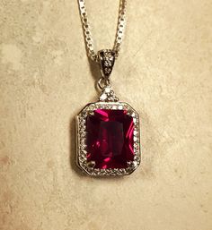 "Stunning Ruby Red Gem Rectangular  Necklace, 8x10mm Emerald Cut Lab Created Simulated Ruby, See Video! 925 Sterling Silver Cubic Zirconia Trimmed Pendant, Rhodium Plated, 18\" Sterling Chain. Gift Box Included." Luxury Ruby Teardrop Pendant Jewelry, Luxury Ruby Jewelry With Rectangular Stone, Red Gem Pendant, Classic Silver Necklace With Rectangular Stone, Dazzling Rectangular Jewelry For Gift, Red Gemstone Jewelry With Rectangular Stone, Red Rectangular Gemstone Jewelry, Elegant Red Necklace With Square Pendant, Silver Necklace With Rectangular Stone For Anniversary