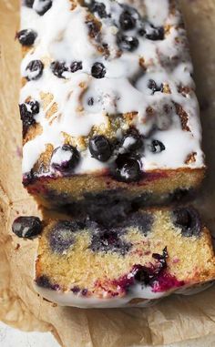 two slices of blueberry bread are sitting on wax paper