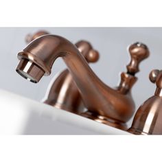 a faucet with two white and brown handles