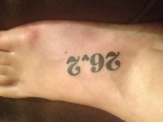 a person has a tattoo on their foot that reads'692'in black ink