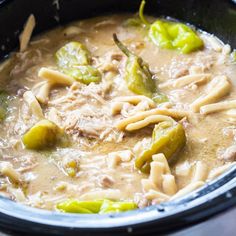 a close up of a bowl of food with noodles and peppers