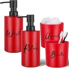 three red bathroom accessories with black lettering on them