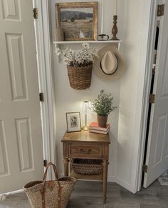 a room with a desk, hat rack and baskets on the wall next to it