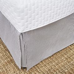 a close up of a bed skirt on the floor with no sheets or pillows in it