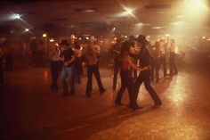 a group of people dancing in a dance hall