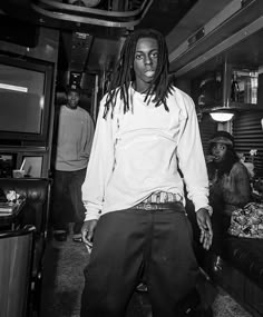 a man with dreadlocks standing in a room