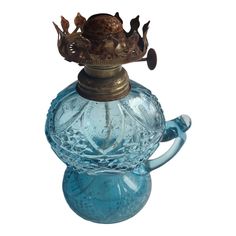 an antique blue glass bottle with a gold crown on it's top and handles