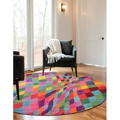 a living room with a colorful rug and chair