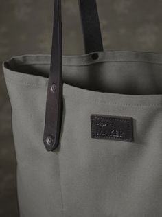 The ultimate carry-all, this sturdy cotton canvas tote with thick leather straps and inside pocket, is functional and durable. The extra-long handles make it super comfortable to carry over shoulders, and fits our everyday essentials, including a laptop.  What we love about it We first discovered Detroit Denim when we Tan Cowhide, Antique Brass Hardware, Denim Tote, The Maker, Flagship Store, Everyday Essentials, Small Leather Goods, Long Handles, Cowhide Leather