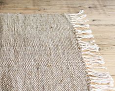 a close up of a rug on a wooden floor